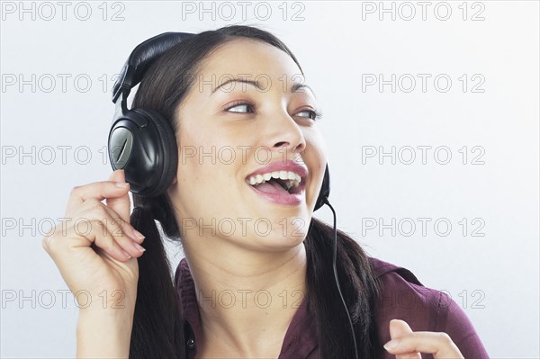 Young woman listening to headphones