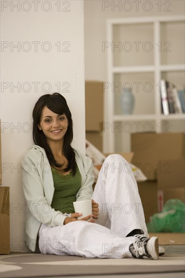 Woman drinking coffee in new house