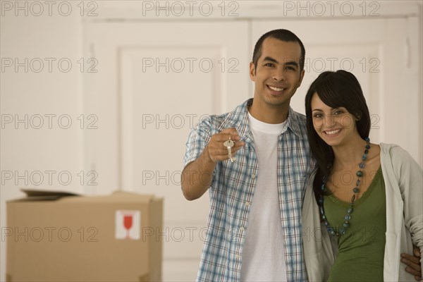 Young couple holding new house keys