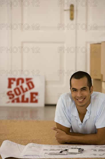 Man with blueprints in new house