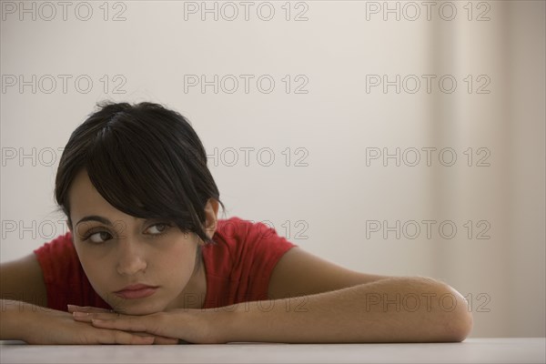 Young woman resting chin on hands