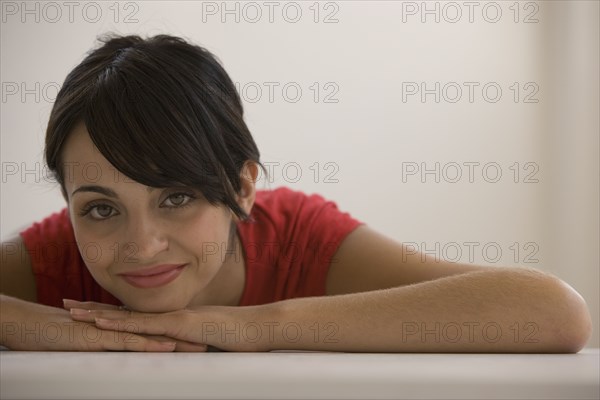 Young woman resting chin on hands