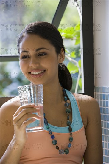 Young woman drinking glass of water