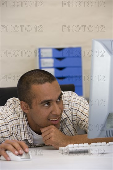 Young businessman looking at computer