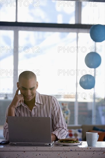 African American man looking at laptop