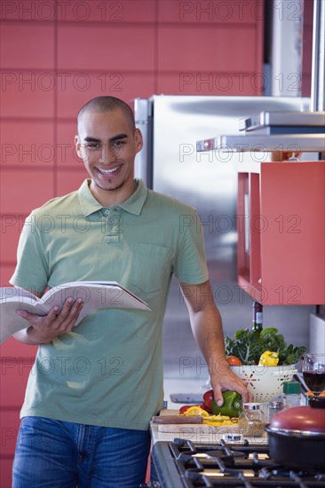 African American man reading cookbook