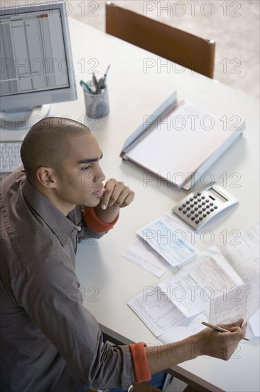 African American man paying bills online