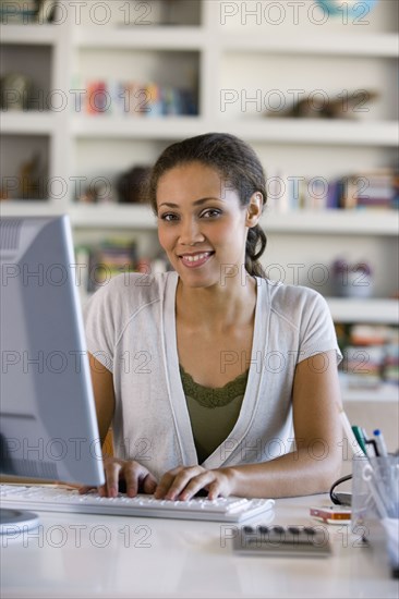 African American woman typing on computer
