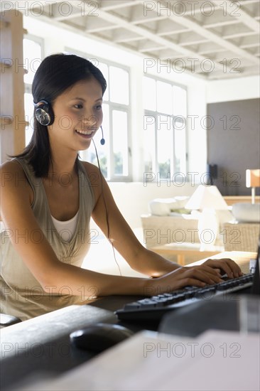 Asian businesswoman wearing headset