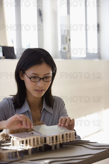 Asian female architect building model