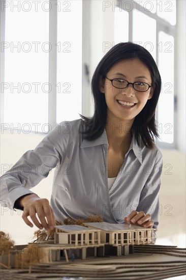 Asian female architect building model