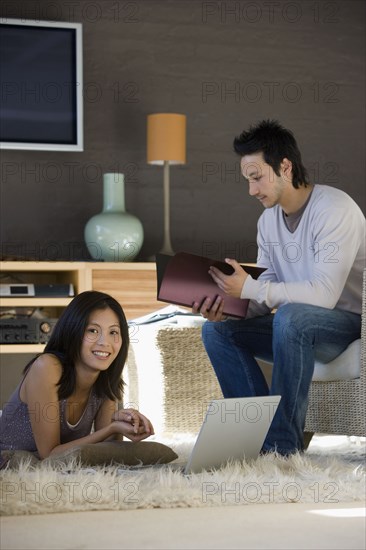 Asian couple working at home