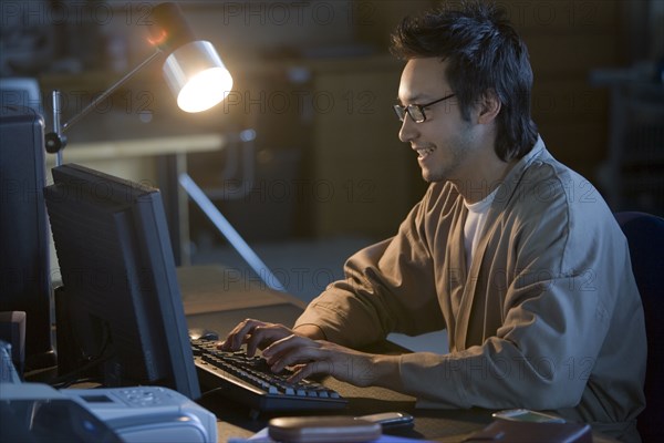 Asian businessman typing on computer