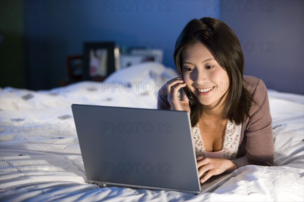 Asian woman talking on cell phone