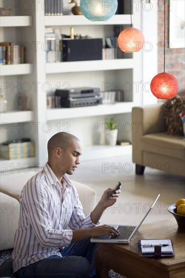 African American man looking at cell phone