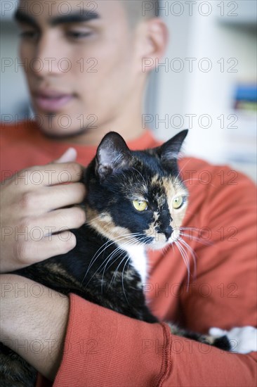 African American man petting cat