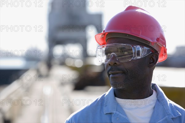 African American male construction worker wearing hardhat