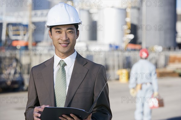 Asian businessman wearing hardhat