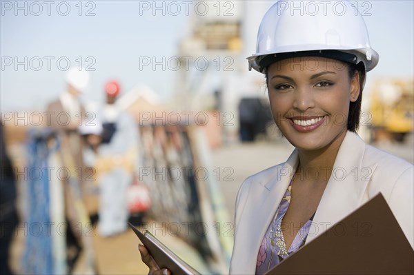 African American businesswoman wearing hardhat