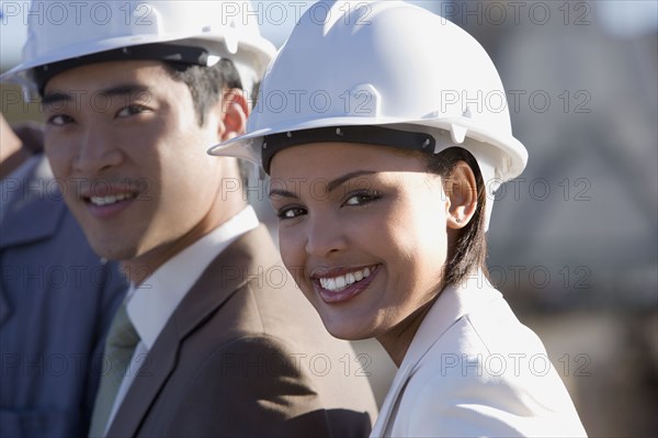 Multi-ethnic businesspeople wearing hardhats