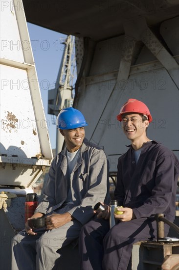 Multi-ethnic male construction workers drinking coffee