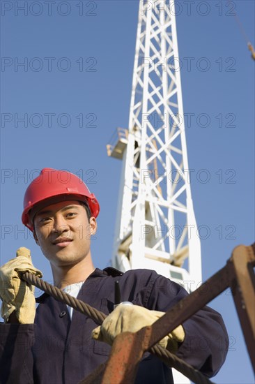 Asian male construction worker wearing hardhat