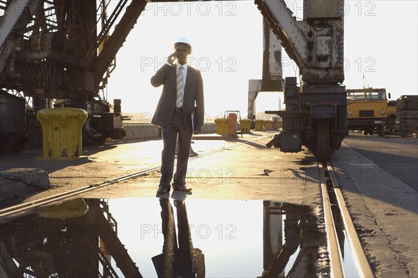 African American businessman wearing hardhat