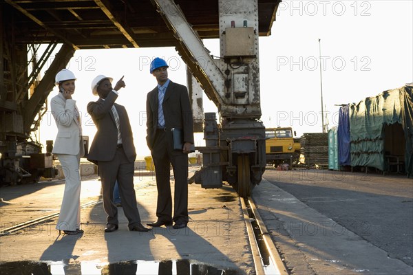 African American businesspeople wearing hardhats