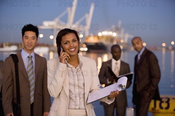 Multi-ethnic businesspeople in front of water