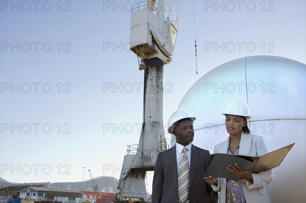 African American businesspeople wearing hardhats