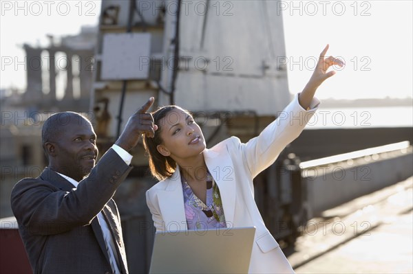 African American businesspeople pointing up