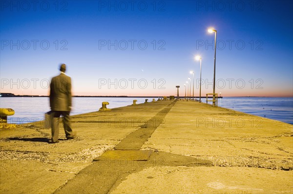 African American businessman walking on commercial pier