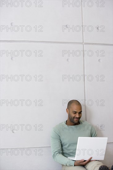 African man looking at laptop