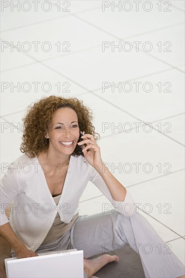 African businesswoman talking on cell phone