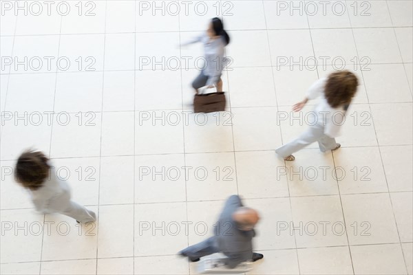 Blurred motion shot of businesspeople walking