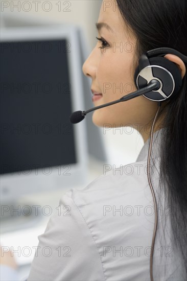 Asian businesswoman wearing headset