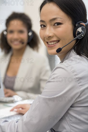 Asian businesswoman wearing headset