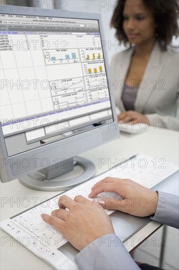 Businesswoman typing on laptop