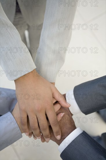 Multi-ethnic businesspeople's hands in huddle