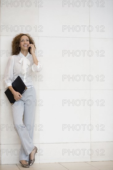 African businesswoman talking on cell phone