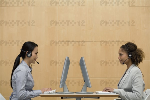 Multi-ethnic businesswomen wearing headsets