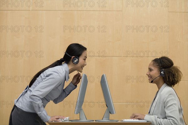 Multi-ethnic businesswomen wearing headsets