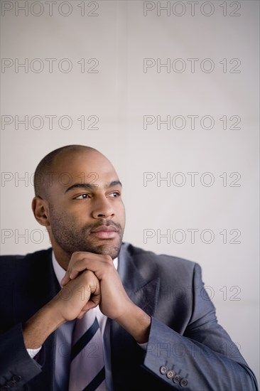 African businessman resting chin on hands