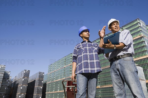 Manager talking with worker at processing plant