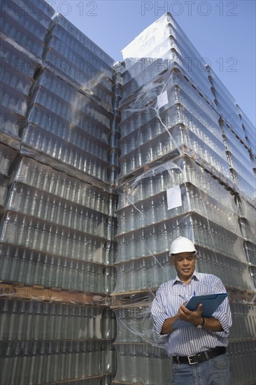 Manager talking with worker at processing plant