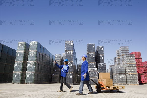 Manager talking with worker at processing plant