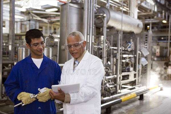 Scientist talking to factory worker