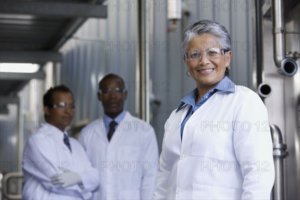 African scientists standing in factory