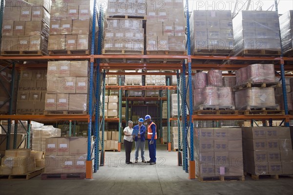 Workers talking in warehouse