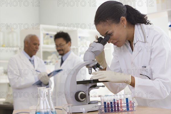 African scientist performing analysis in laboratory with microscope